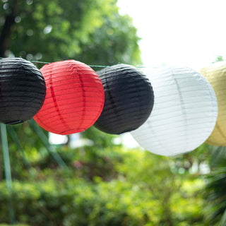 Colorful paper lanterns hanging outdoors in a garden setting.