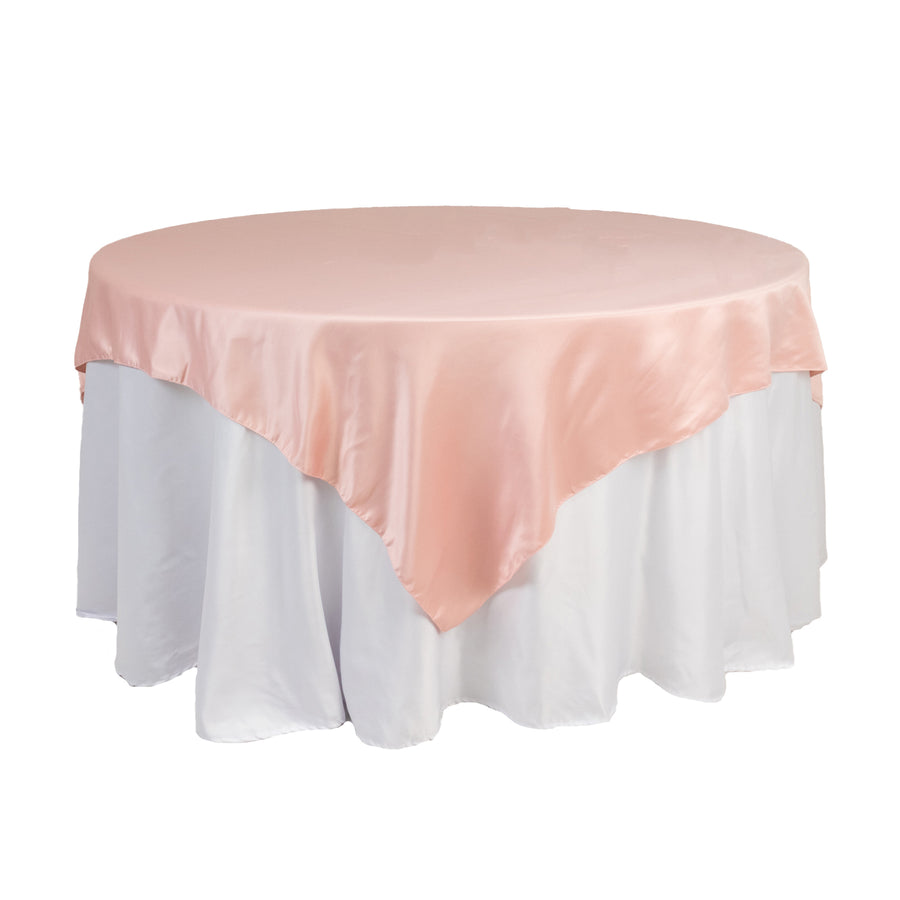 Round table with elegant pink satin tablecloth