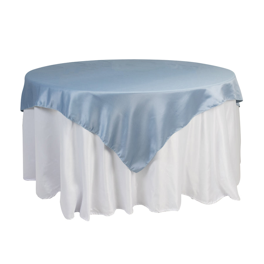 Round table with blue satin tablecloth and white skirt