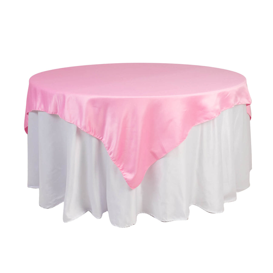Pink satin tablecloth with white underneath for events and celebrations.