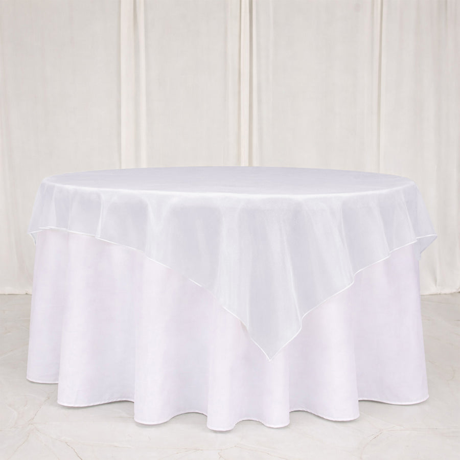 White round tablecloth with layered ruffle overlay on a table