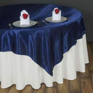 Elevate Your Event Decor with the 90"x90" Navy Satin Square Table Overlay Elevate Your Event Decor with the 90"x90" Navy Satin Square Table Overlay