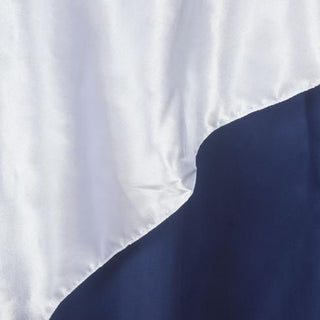 White and navy blue satin fabric draped elegantly.
