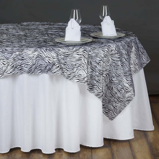 Elevate Your Jungle Theme Party with the 90"x90" Black and White Tiger Print Taffeta Square Table Overlay Elevate Your Jungle Theme Party with the 90"x90" Black and White Tiger Print Taffeta Square Table Overlay
