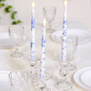 Elegant blue and white candles in crystal holders on a dining table.
