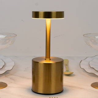 Modern brass table lamp with a sleek design and warm glow.