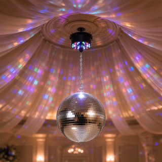 Disco ball hanging from ceiling with colorful party light reflections