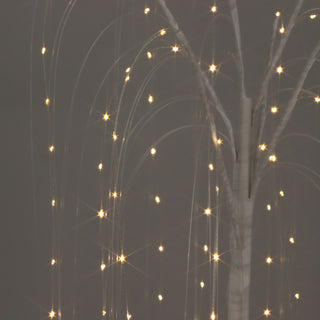 Illuminated decorative tree with twinkling lights against a dark background.