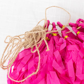 Pink tissue paper garland with twine for decoration.