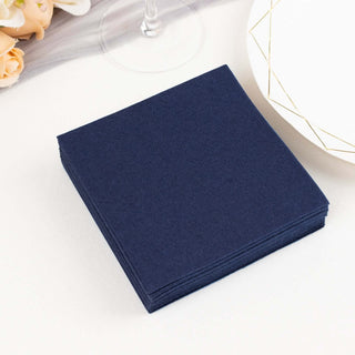 Navy blue paper napkins stacked on a table