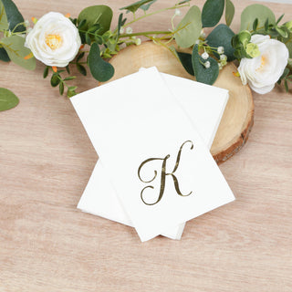 Elegant white notecards with a gold letter "K" on a wooden surface.