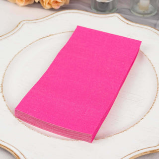 Pink tissue paper stack on a decorative plate.
