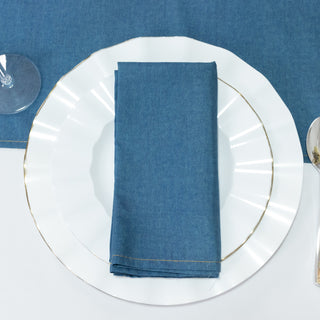 Blue linen napkin elegantly folded on a white plate.