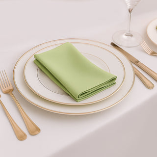 Green napkin elegantly placed on a fine dining table setting.