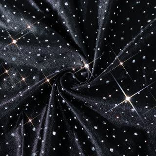 Black fabric with shimmering silver dots and sparkles.