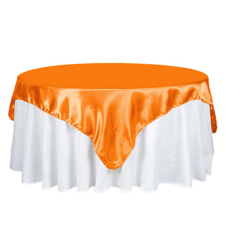 Add a Pop of Elegance with the 72x72 Orange Satin Square Tablecloth Overlay Add a Pop of Elegance with the 72x72 Orange Satin Square Tablecloth Overlay