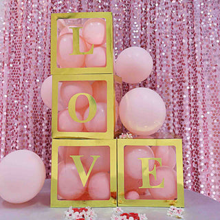 Gold and pink decorative blocks spelling "LOVE" with balloons