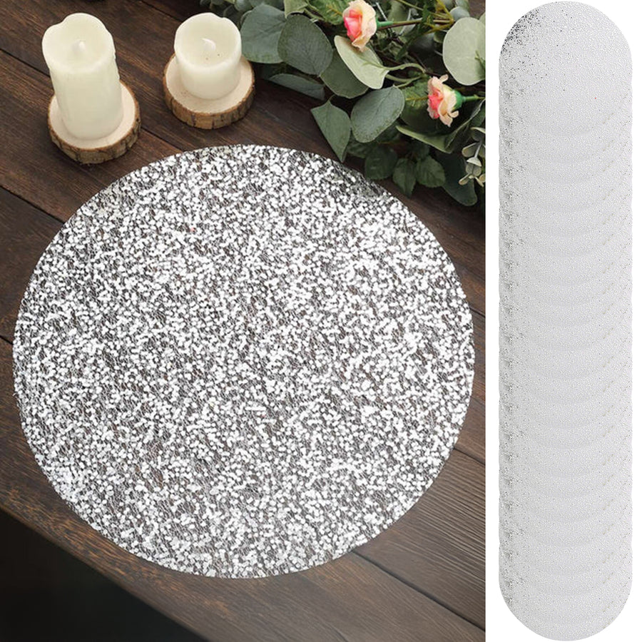 Silver glitter table runner on a wooden surface with candles and flowers.