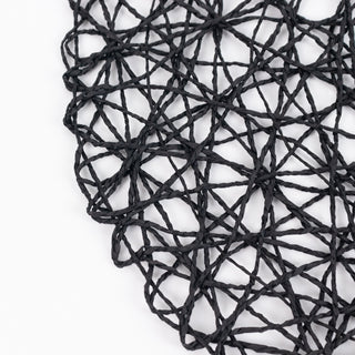 Close-up of black woven placemat texture on white background