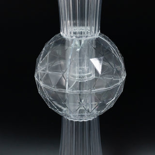 Clear geometric glass vase with a textured surface.
