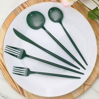 Green eco-friendly utensils set on a white plate.