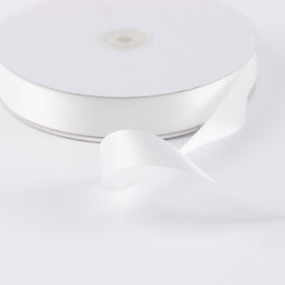 White satin ribbon spool on a white background, close-up product shot