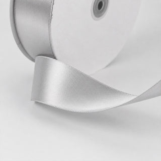 Silver satin ribbon on white gift box with hole detail