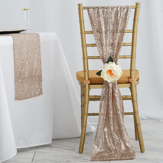 Gold sequin chair sash adorned with a white flower, styled on a decorative chair.