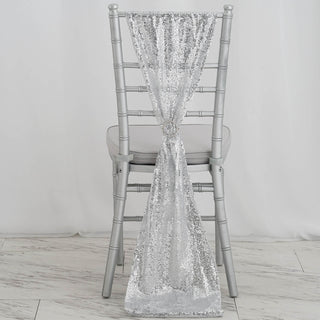 Silver sequin chair sash draped elegantly on a silver chiavari chair.