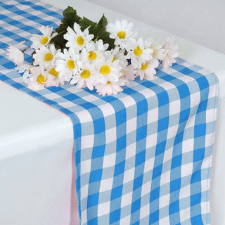 Blue checkered table runner with white daisies centerpiece