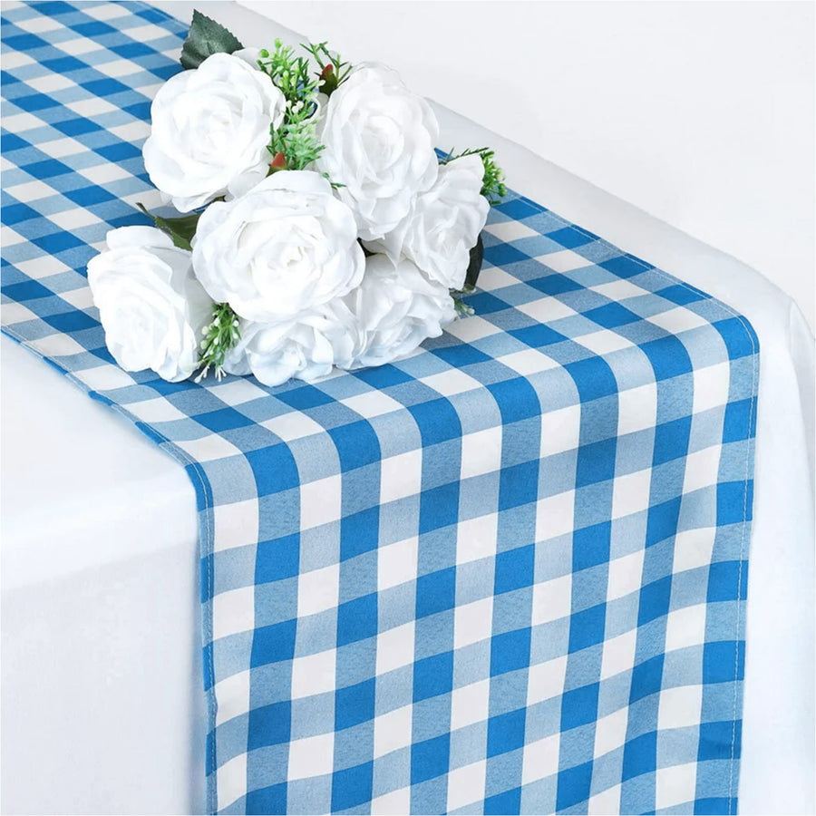 Blue and white checkered table runner with white rose bouquet centerpiece