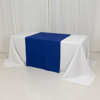 White table with a blue table runner in a studio-style setup.