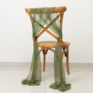 Olive green sheer fabric draped on a wooden chair.