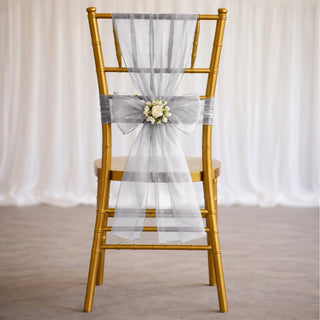 Gold chiavari chair with silver sheer wedding bow and floral centerpiece