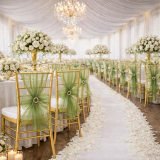 Elegant wedding reception setup with gold chairs and floral decorations.