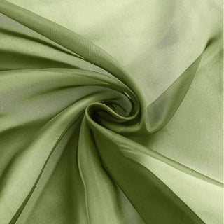 Green sheer fabric swirl, showcasing its lightweight texture and flow. #whtbkgd
