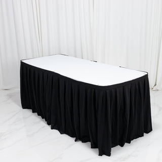 Black pleated banquet table skirt with white tabletop in event setup