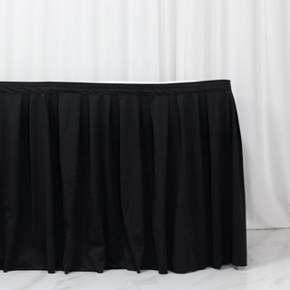 Black pleated table skirt on white backdrop, event table cover