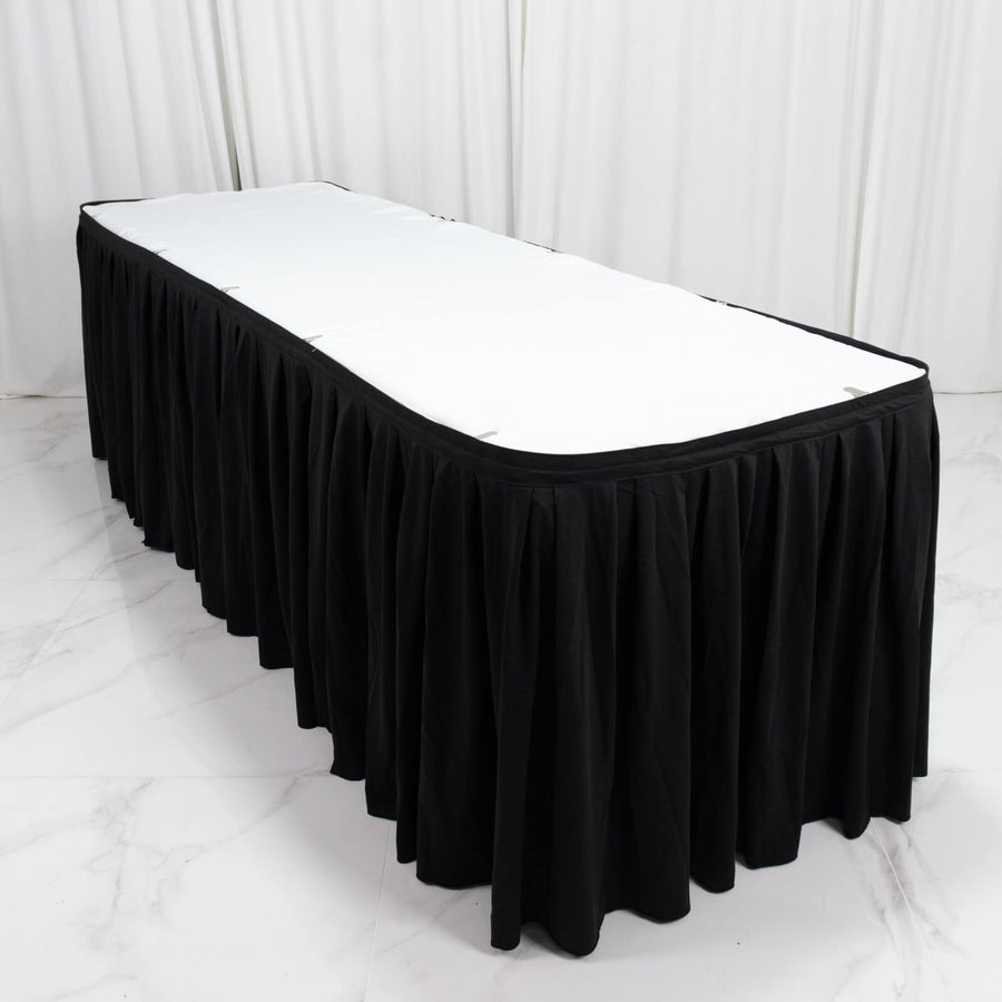 Black rectangular table skirt with white tabletop in a studio setting