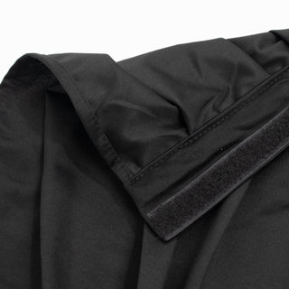 Black fabric garment close-up with Velcro cuff detail