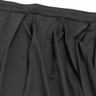 Black pleated skirt fabric close-up with waistband detail