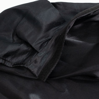 Black fabric texture with folded seams close-up