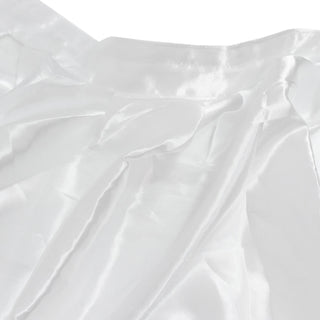 White satin fabric texture with soft folds and sheen