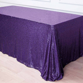Purple sequin tablecloth draped on a table.