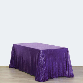 Purple sequin tablecloth draped over a rectangular table