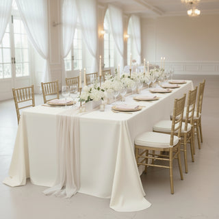 Elegant dining table set with flowers and candles in a sophisticated venue.