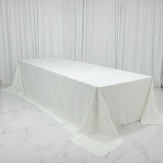 White tablecloth draped elegantly over a table in a studio setting.