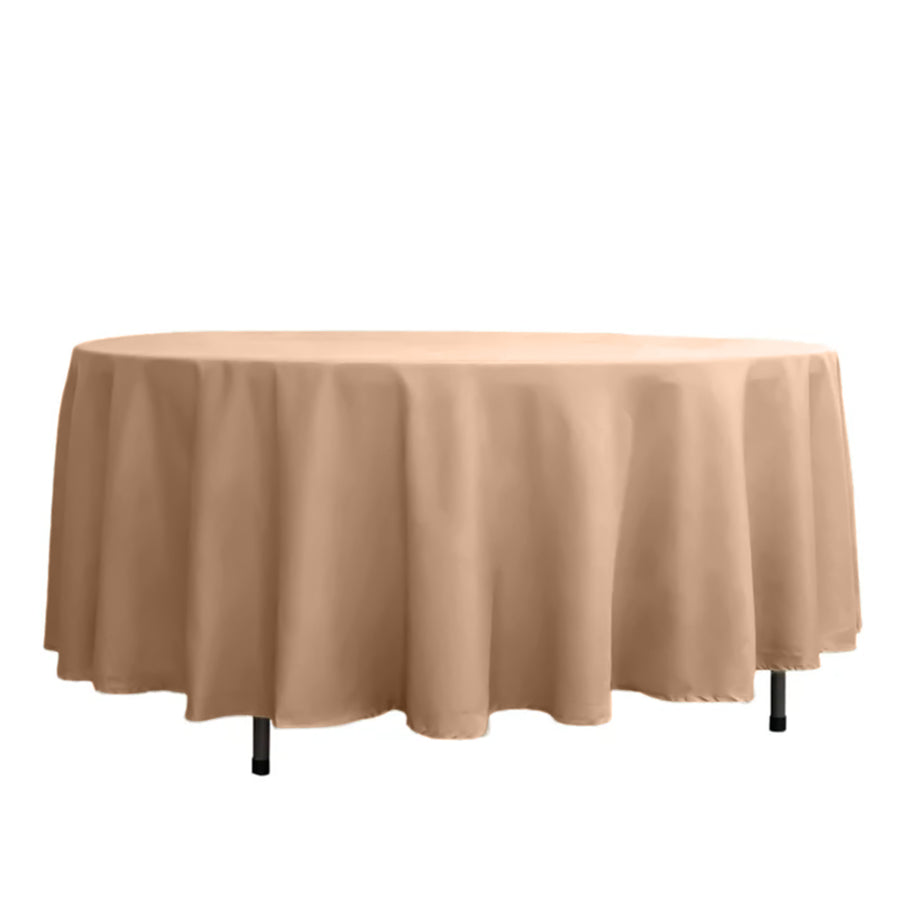 Round table covered with a beige tablecloth