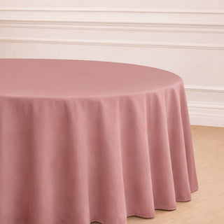 Round pink tablecloth draping elegantly over a table in a staged setting.