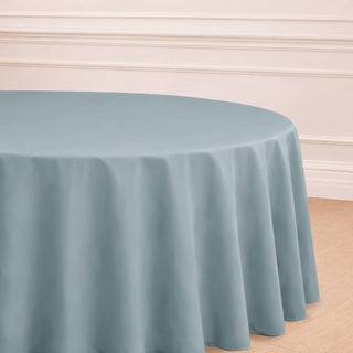 Round blue tablecloth draped elegantly over a table in a styled setting.